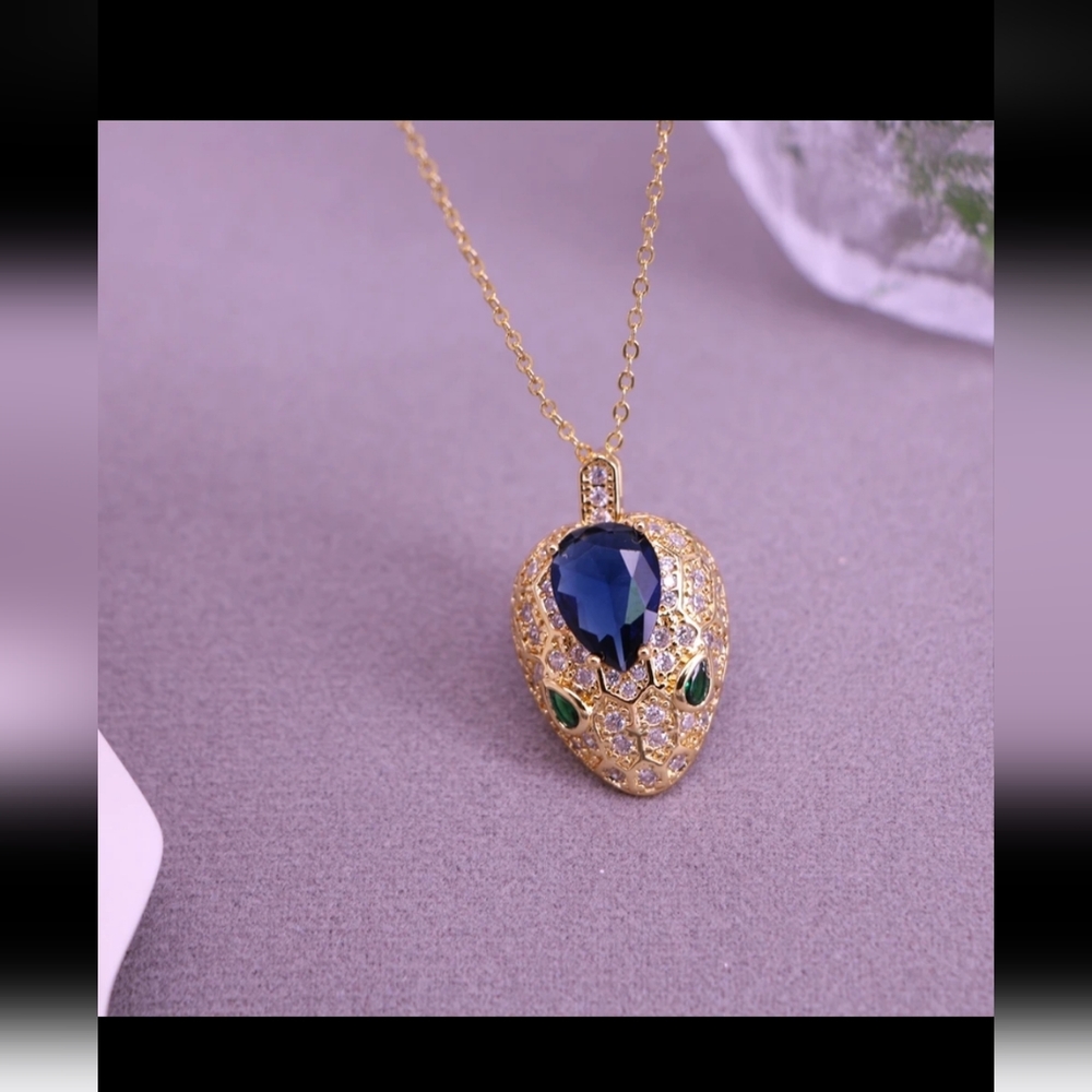 Snake blue stone and gold pendant
